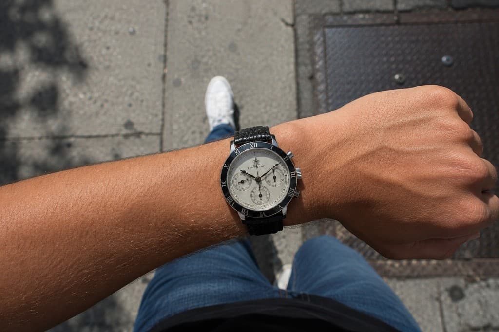 Chronograph watch on a wrist outdoors, viewed from above