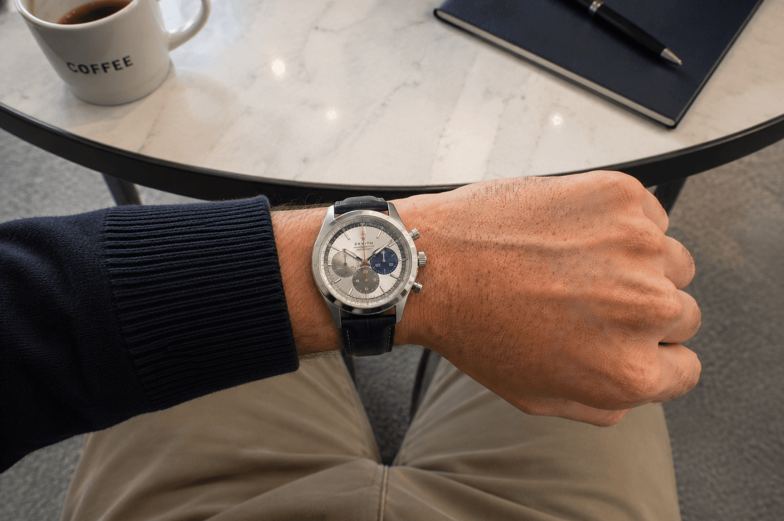 Sport chronograph on a steel bracelet, worn on the wrist